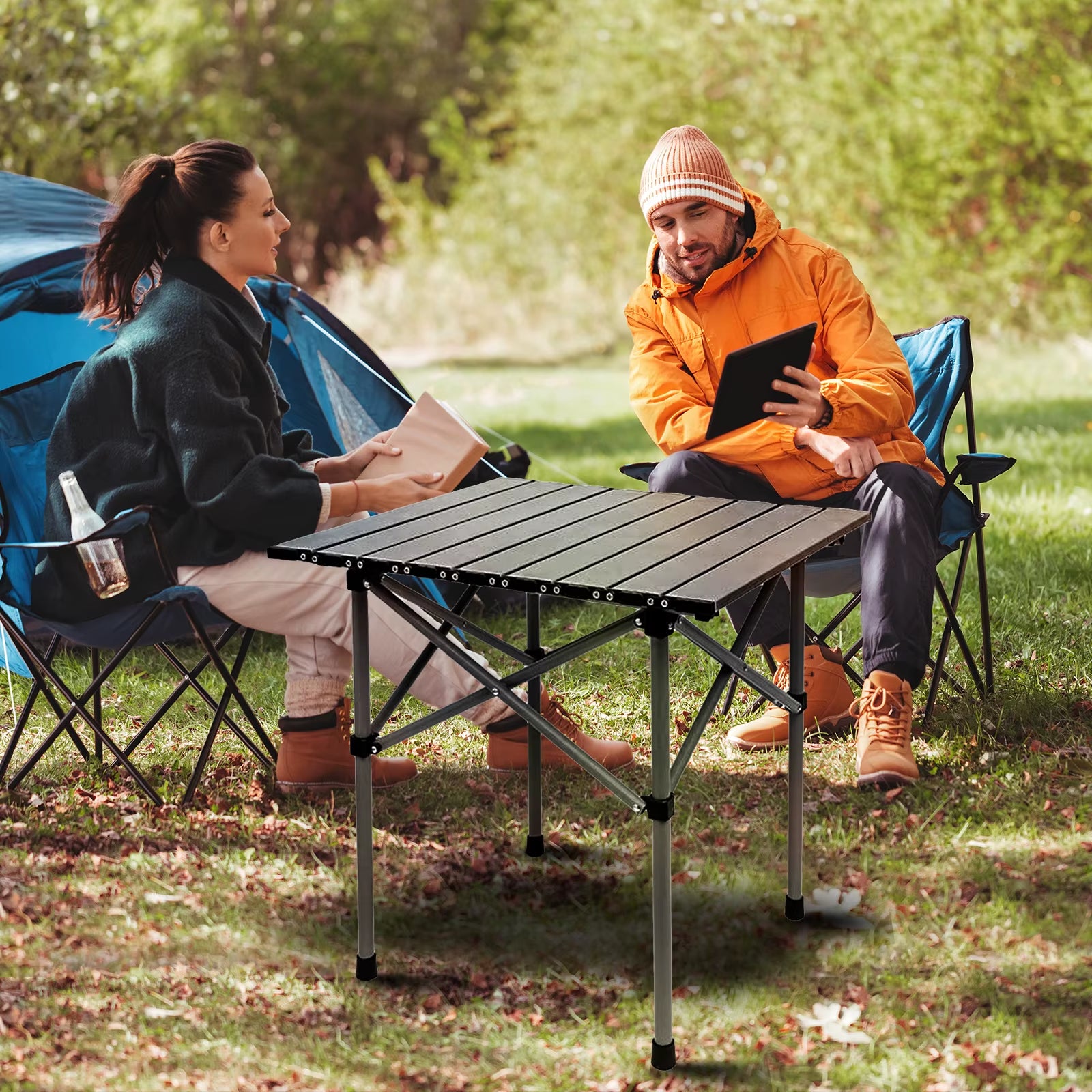 Foldable camping table with aluminum alloy top rolled up for portability